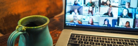 Image of a laptop next to a mug
