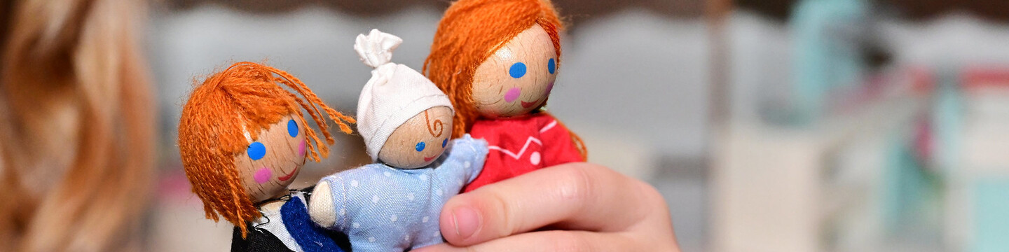 Three different small wooden dolls